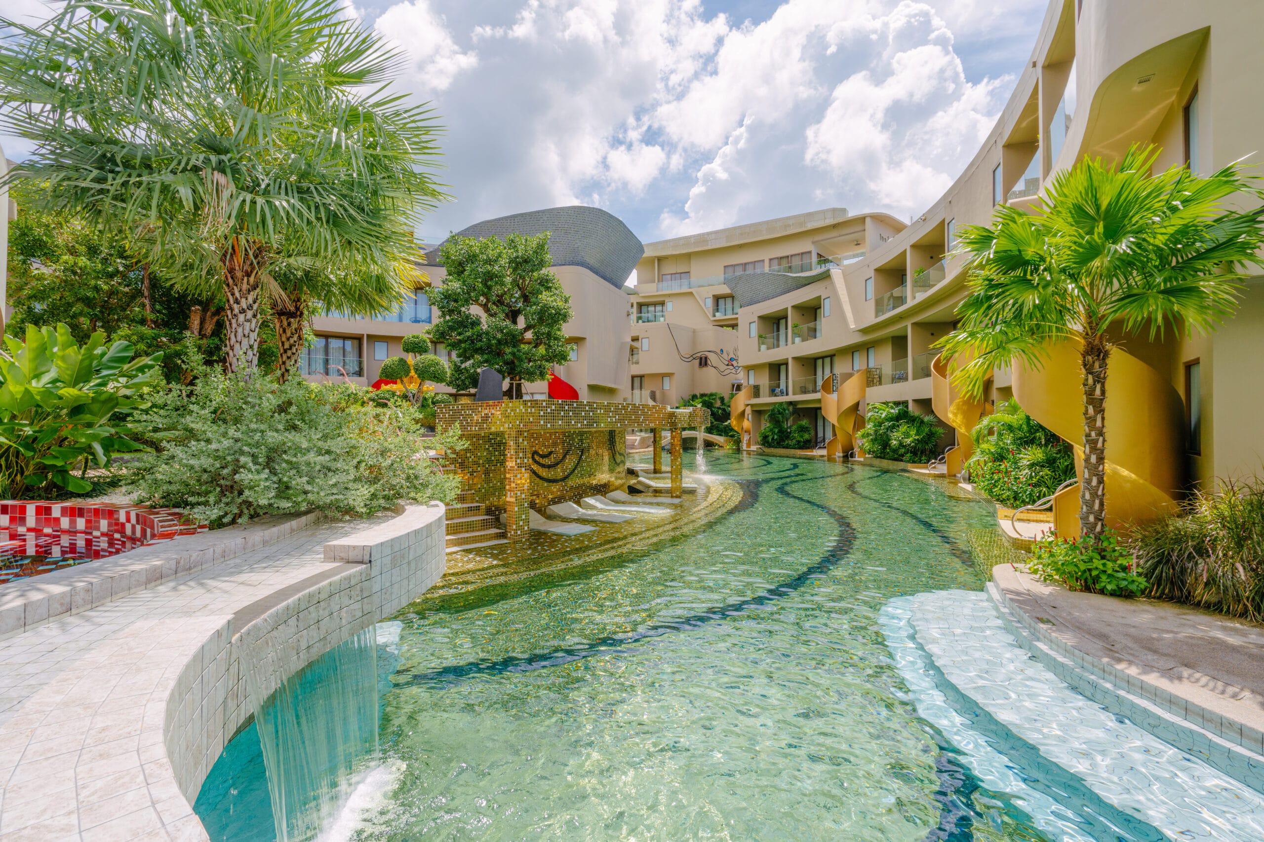 Lagoon-style swimming pool surrounded by tropical greenery at Metadee Concept Hotel