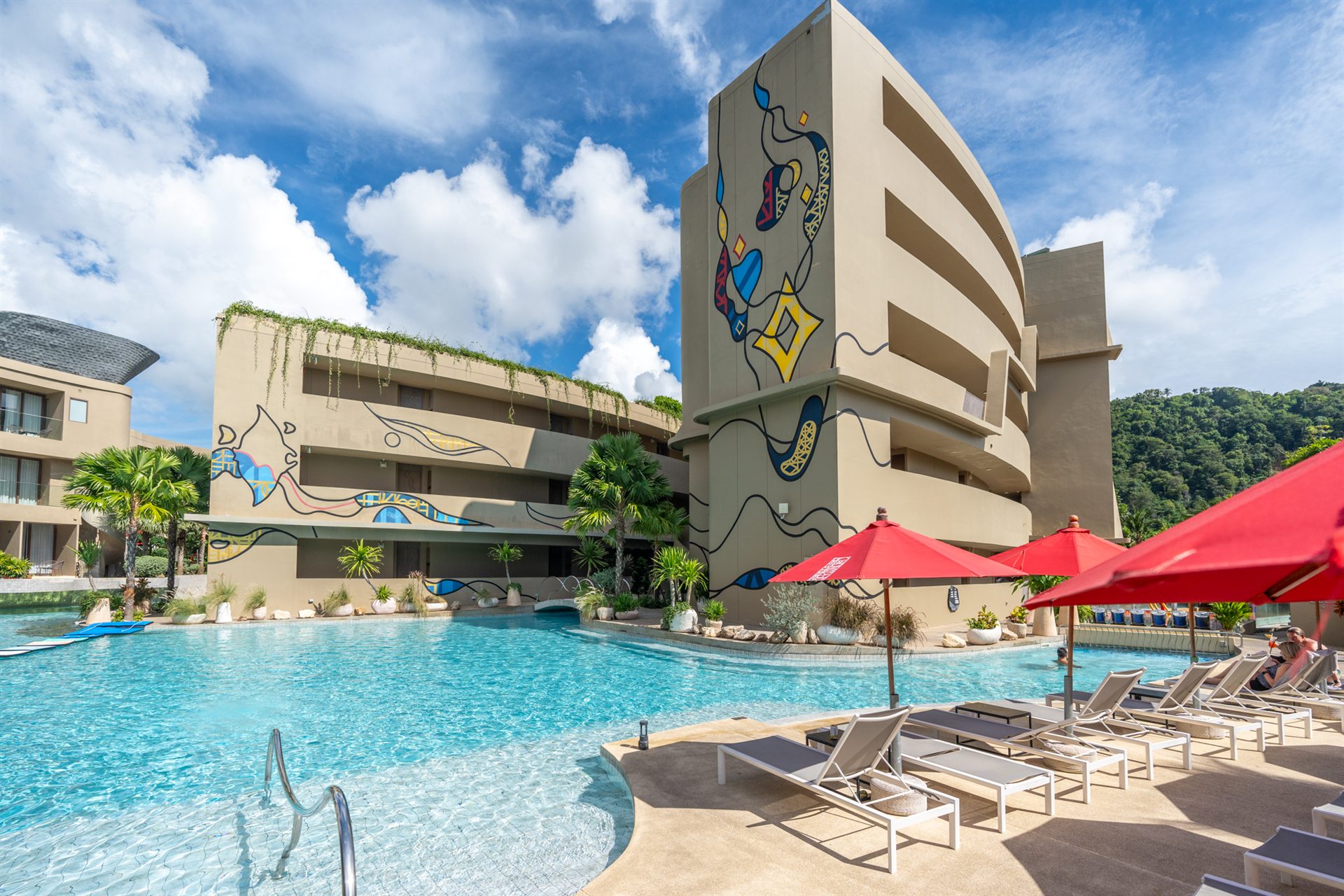 Swimming pool, sun loungers and resort buildings at Metadee Concept Hotel in Phuket