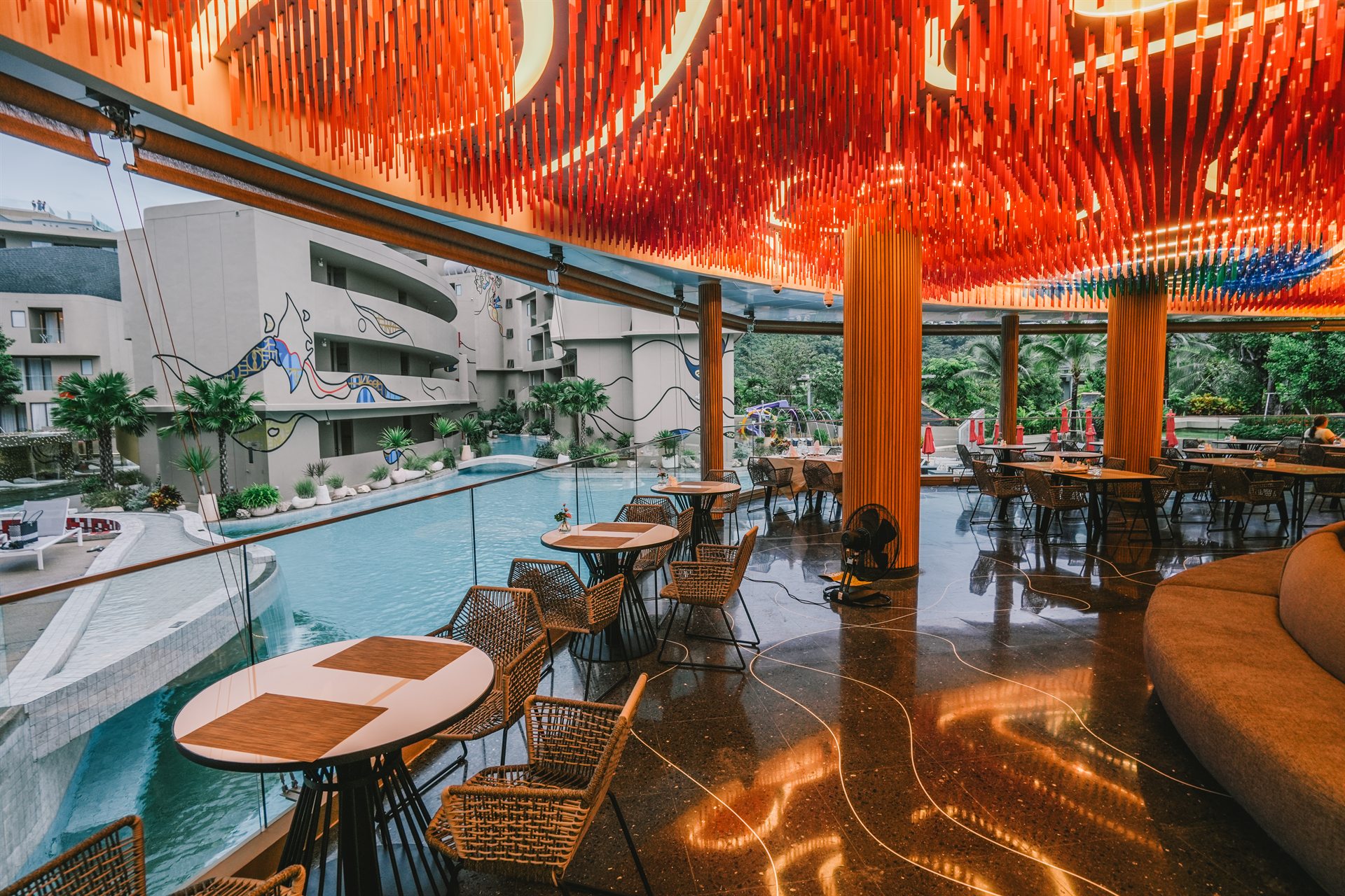 Contemporary Dining Space at Metadee Concept Hotel Phuket Open-air dining area with a sculptural red ceiling beside the pool at Metadee Concept Hotel in Phuket