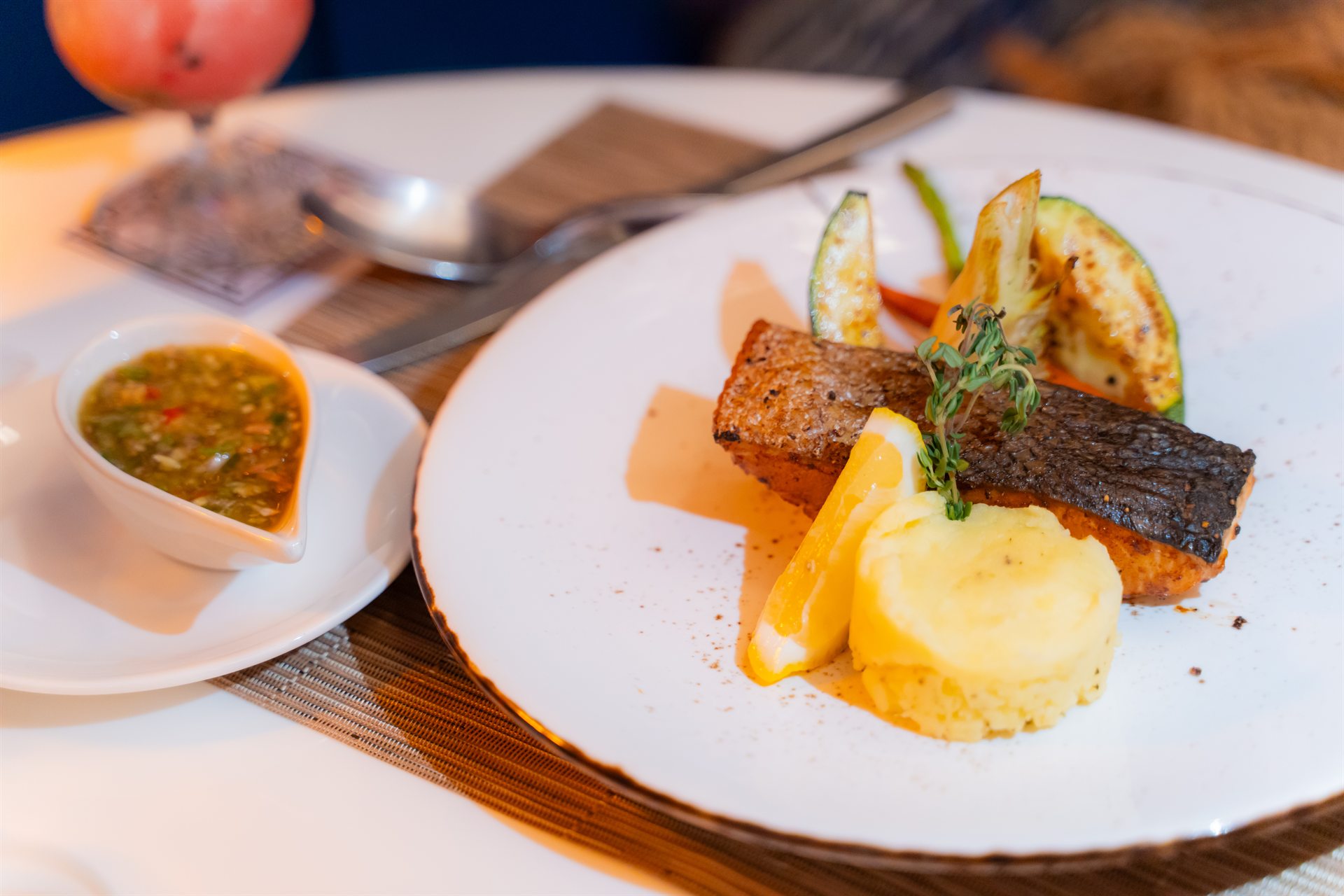 Dining Moments at Metadee Concept Hotel Phuket Salmon fillet served with mashed potato, vegetables, lemon and sauce at Metadee