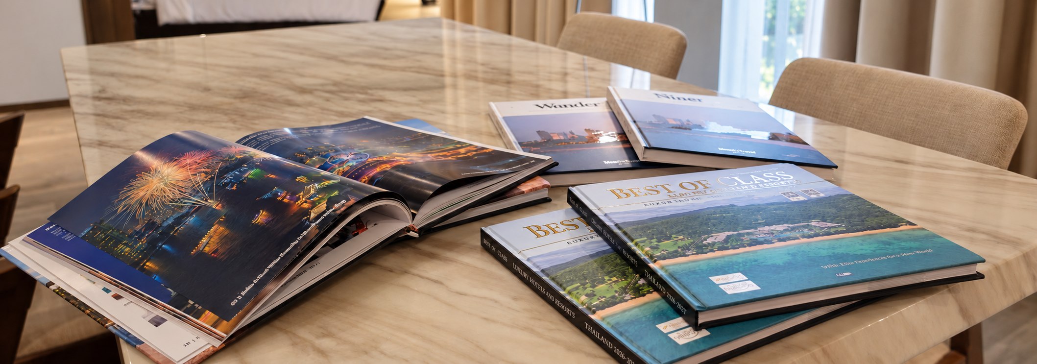 Luxury print publications displayed on a marble table inside a Metadee Concept Hotel suite